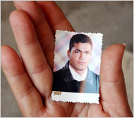 Amaal Abdel Fattah Taha holds a picture of her son, Diaa Eddin Gad, who was taken from his home by security forces last Friday. His whereabouts remain unknown. Credit Shawn Baldwin for The New York Times