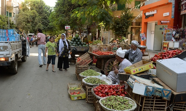 An Egyptian woman and her daughter walk in a crowded street in Cairo. Photograph: Marwan Naamani/AFP/Getty Images